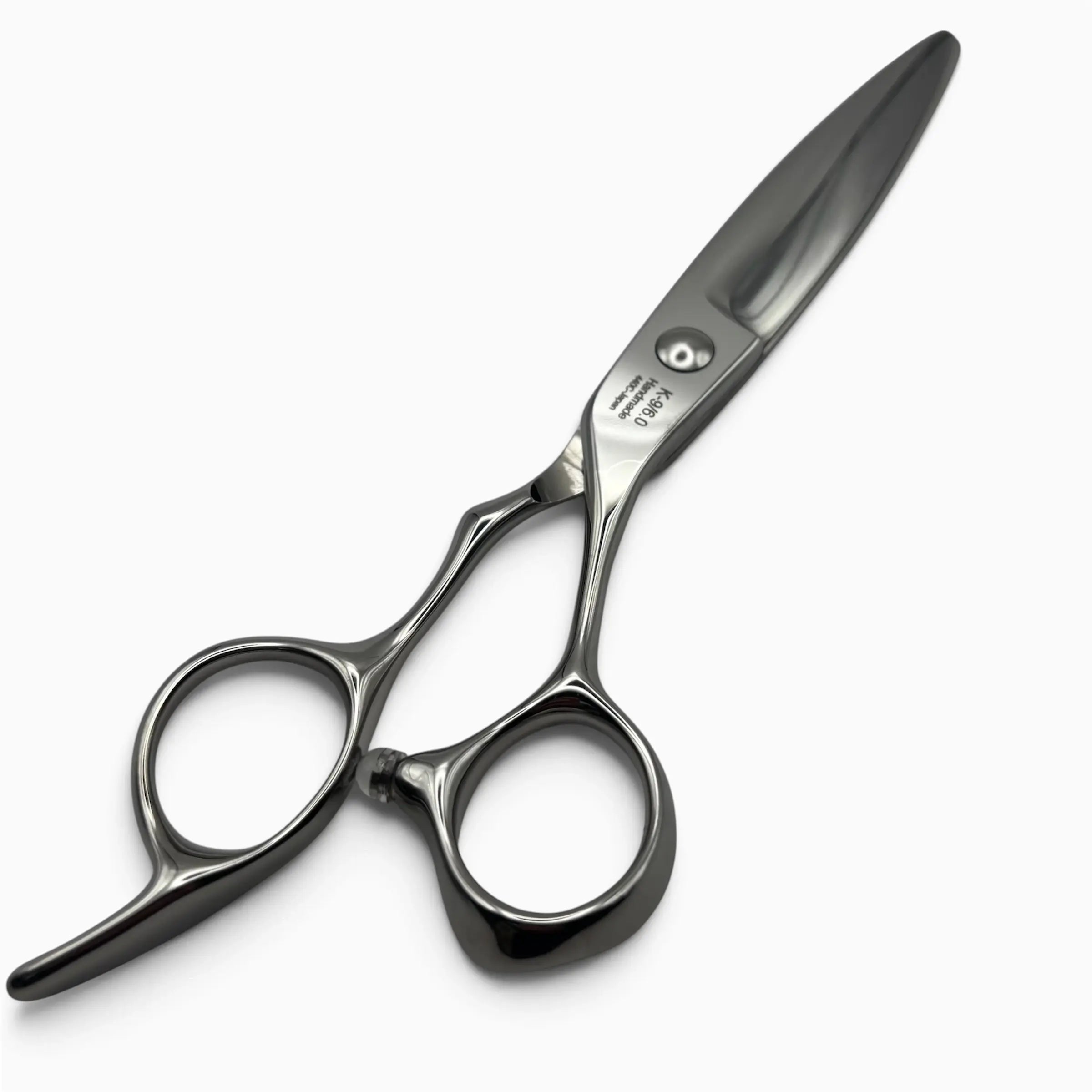 A K-9 of hair shears with a polished silver finish, featuring ergonomic finger loops set against a clean white background.