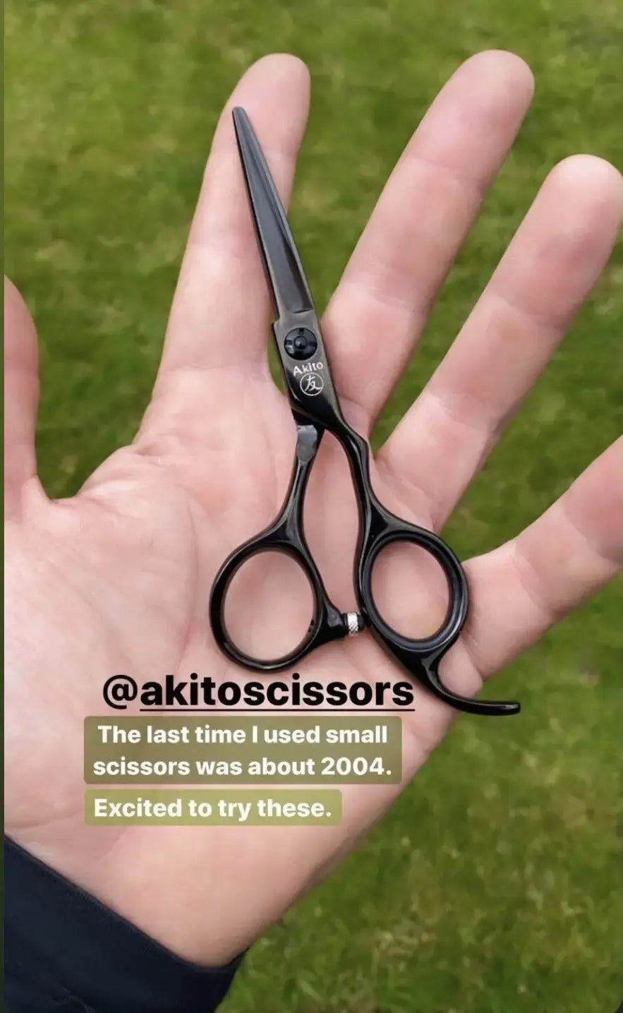 Hand holding a pair of black scissors with text about using small akito scissors last in 2004.