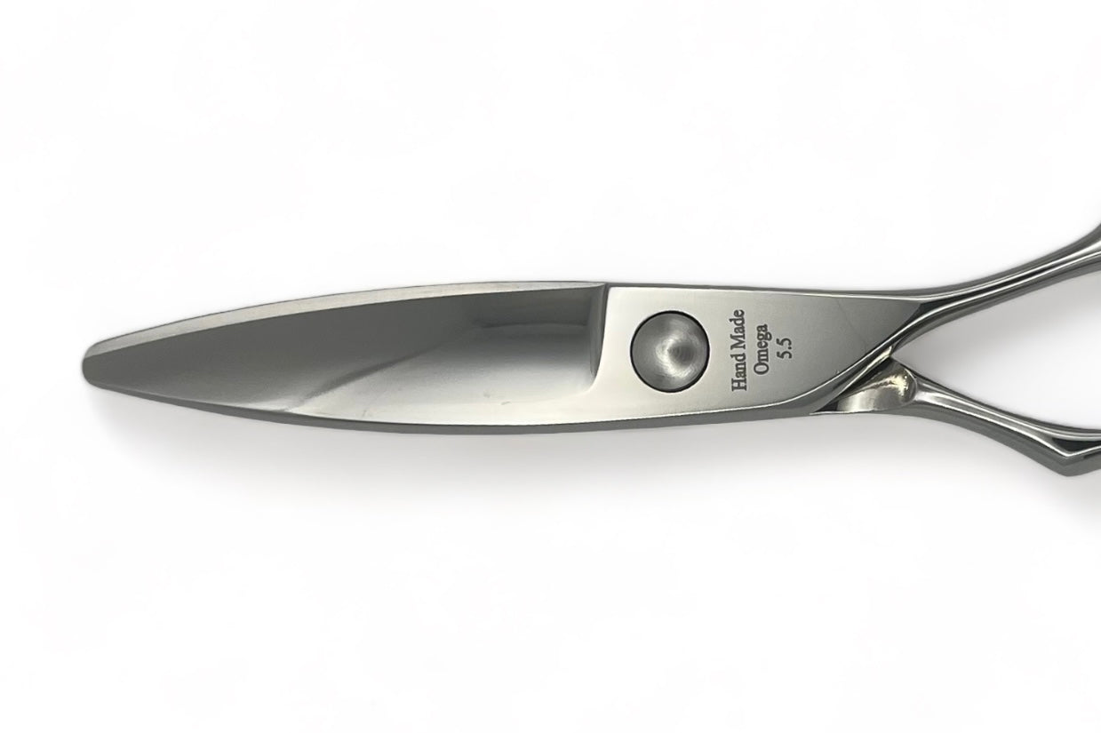 Omega sliding and slicing scissors blade