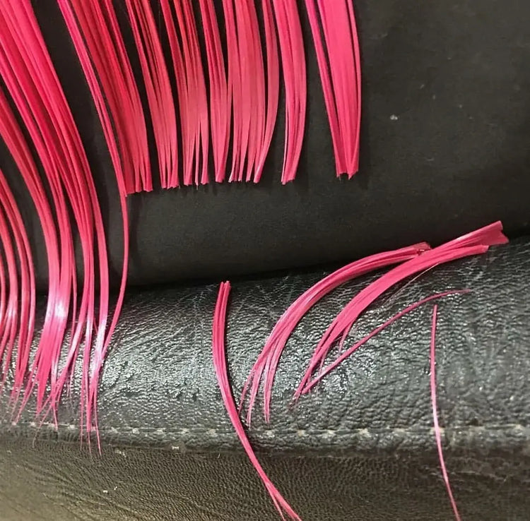Close-up of pink hair extensions on a black background