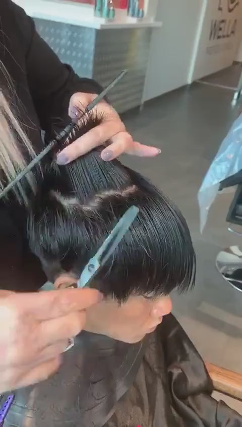 Hairdresser cutting customers hair using black Akito F-2
